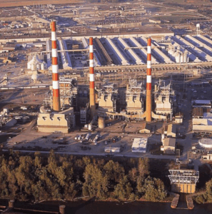 Plant with three orange and white smoke stacks at the Alcoa Warrick site in Indiana